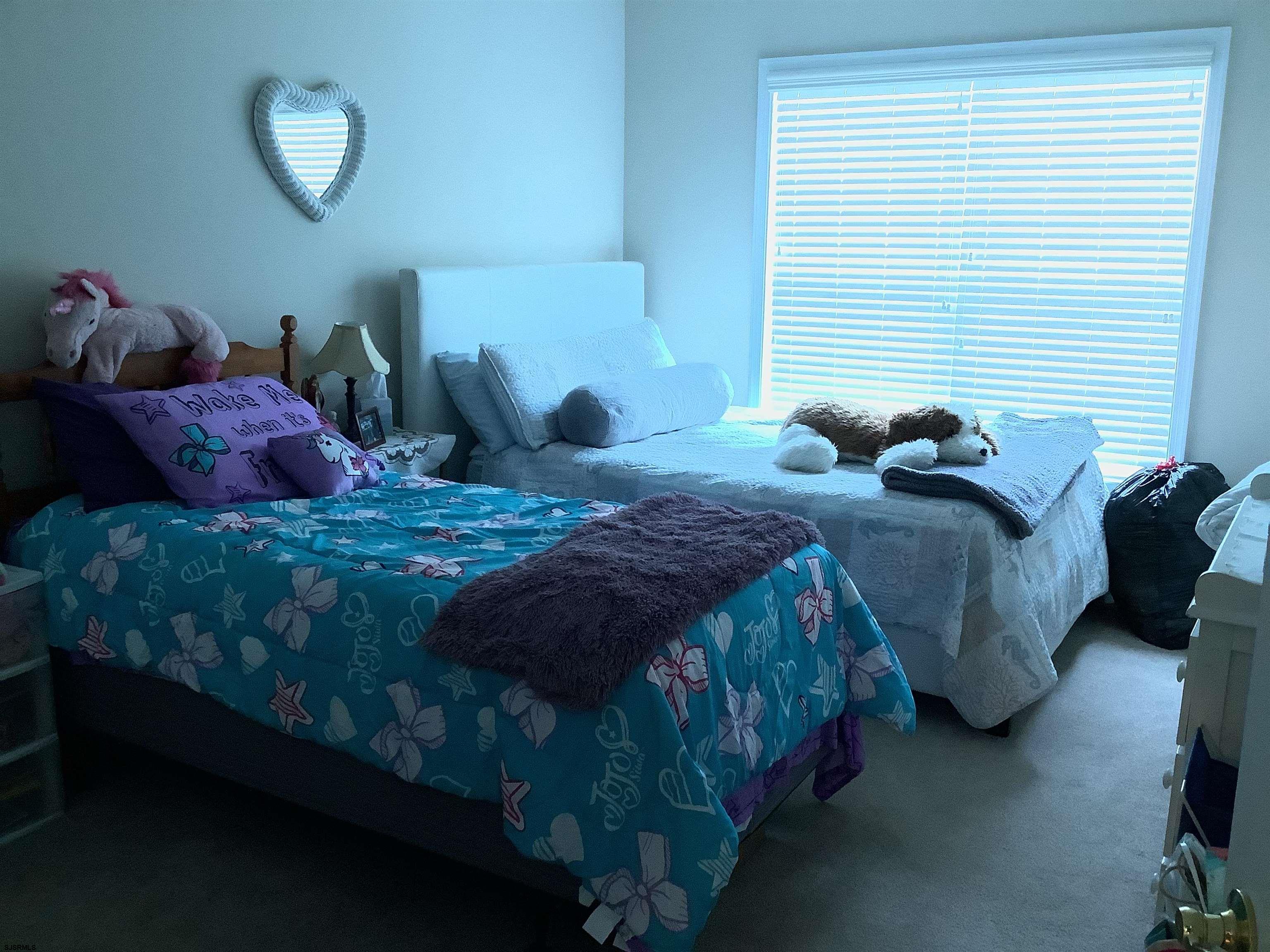 1731 South Shore Road, Unit 128 Marmora, NJ 08230 - Photo 12 of 13 a bedroom with a bed and a window