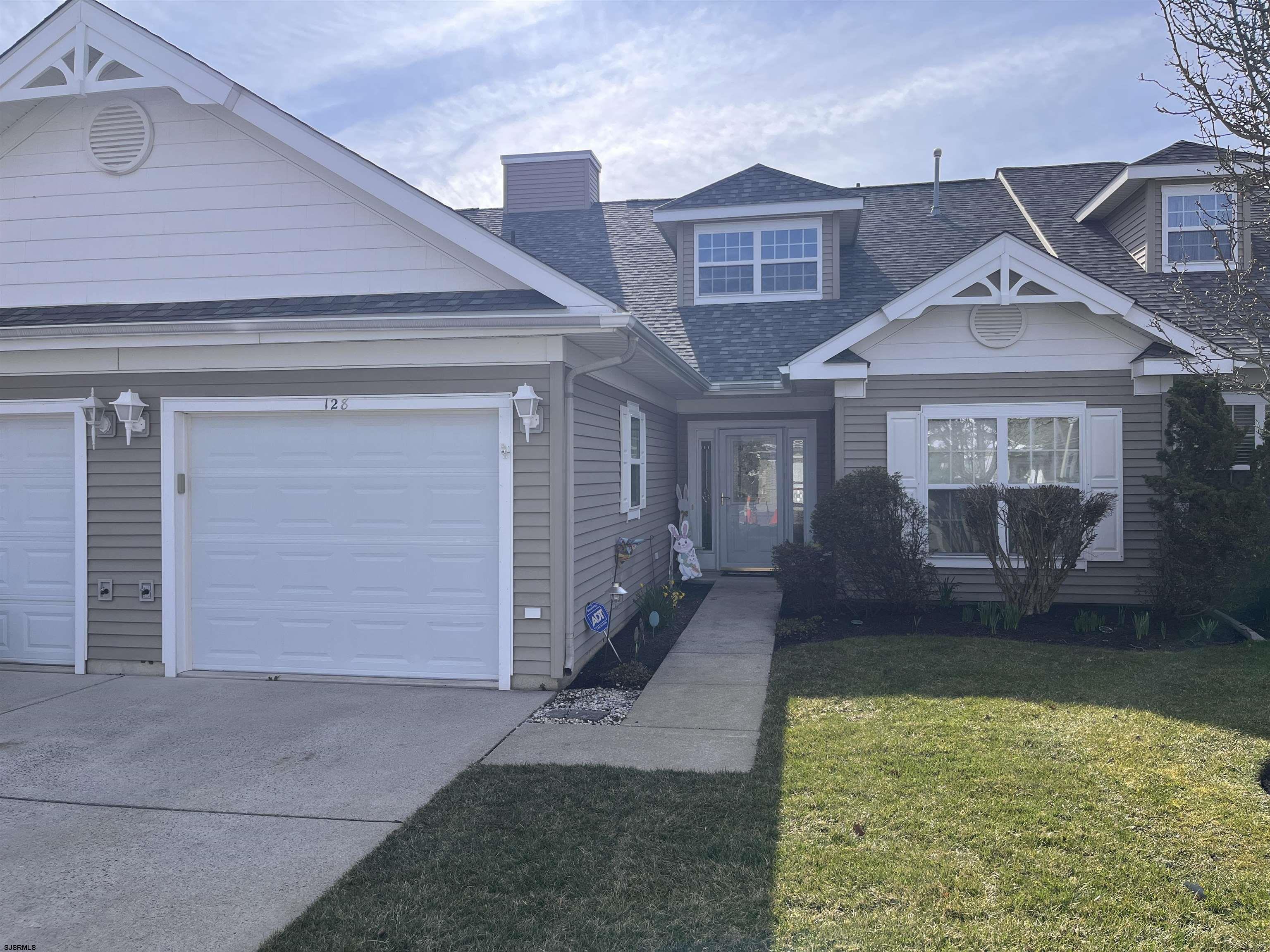 1731 South Shore Road, Unit 128 Marmora, NJ 08230 - Photo 2 of 10 a front view of a house with a yard