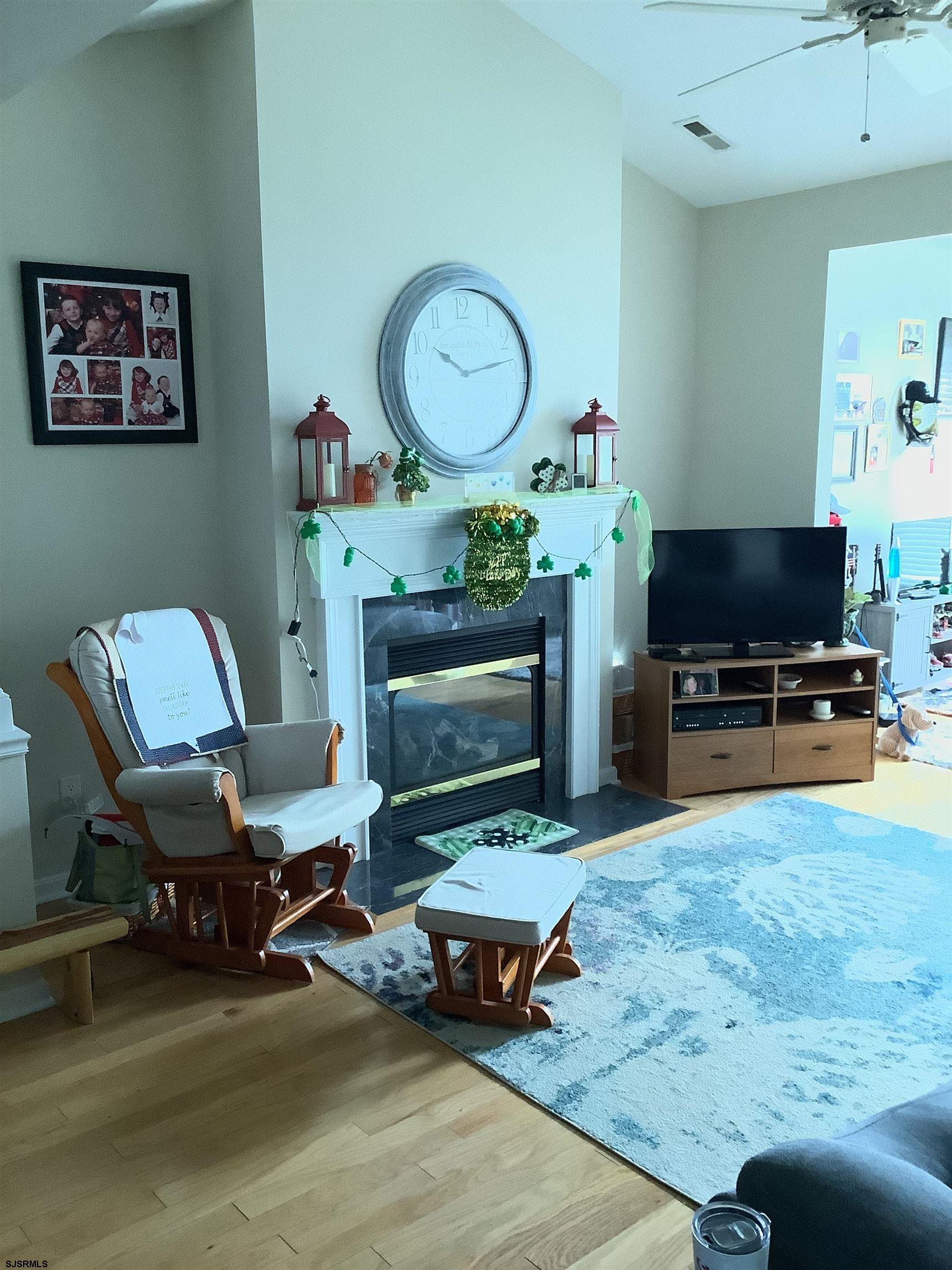 1731 South Shore Road, Unit 128 Marmora, NJ 08230 - Photo 3 of 10 a living room with furniture and a fireplace