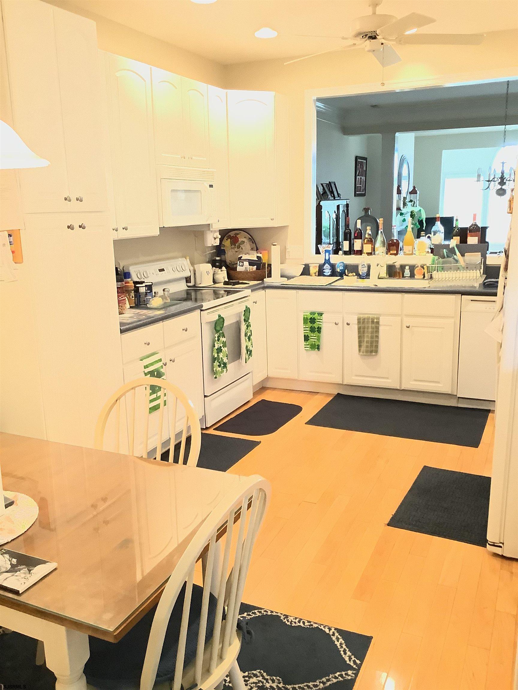 1731 South Shore Road, Unit 128 Marmora, NJ 08230 - Photo 4 of 10 a kitchen with stainless steel appliances kitchen island granite countertop a sink and cabinets