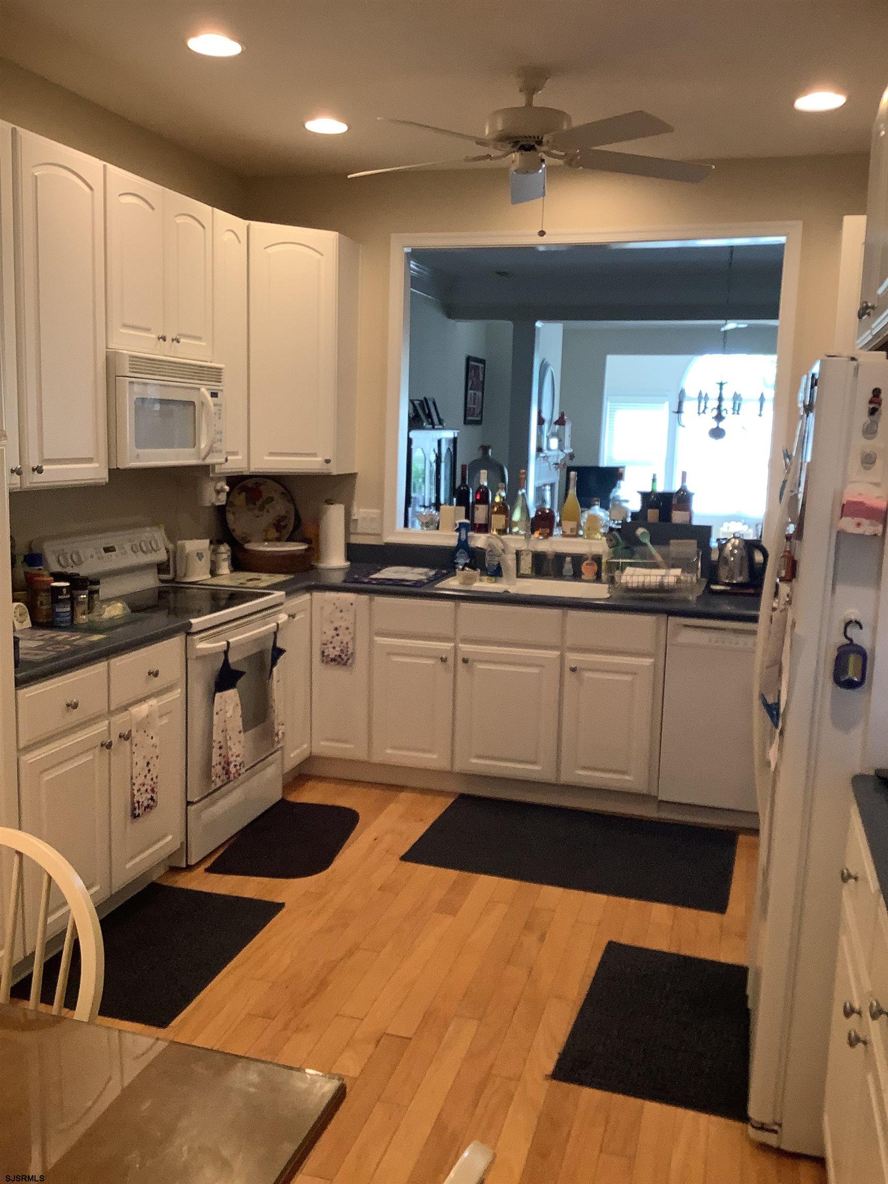 1731 South Shore Road, Unit 128 Marmora, NJ 08230 - Photo 6 of 13 a kitchen with stainless steel appliances granite countertop a sink a stove a refrigerator and cabinets