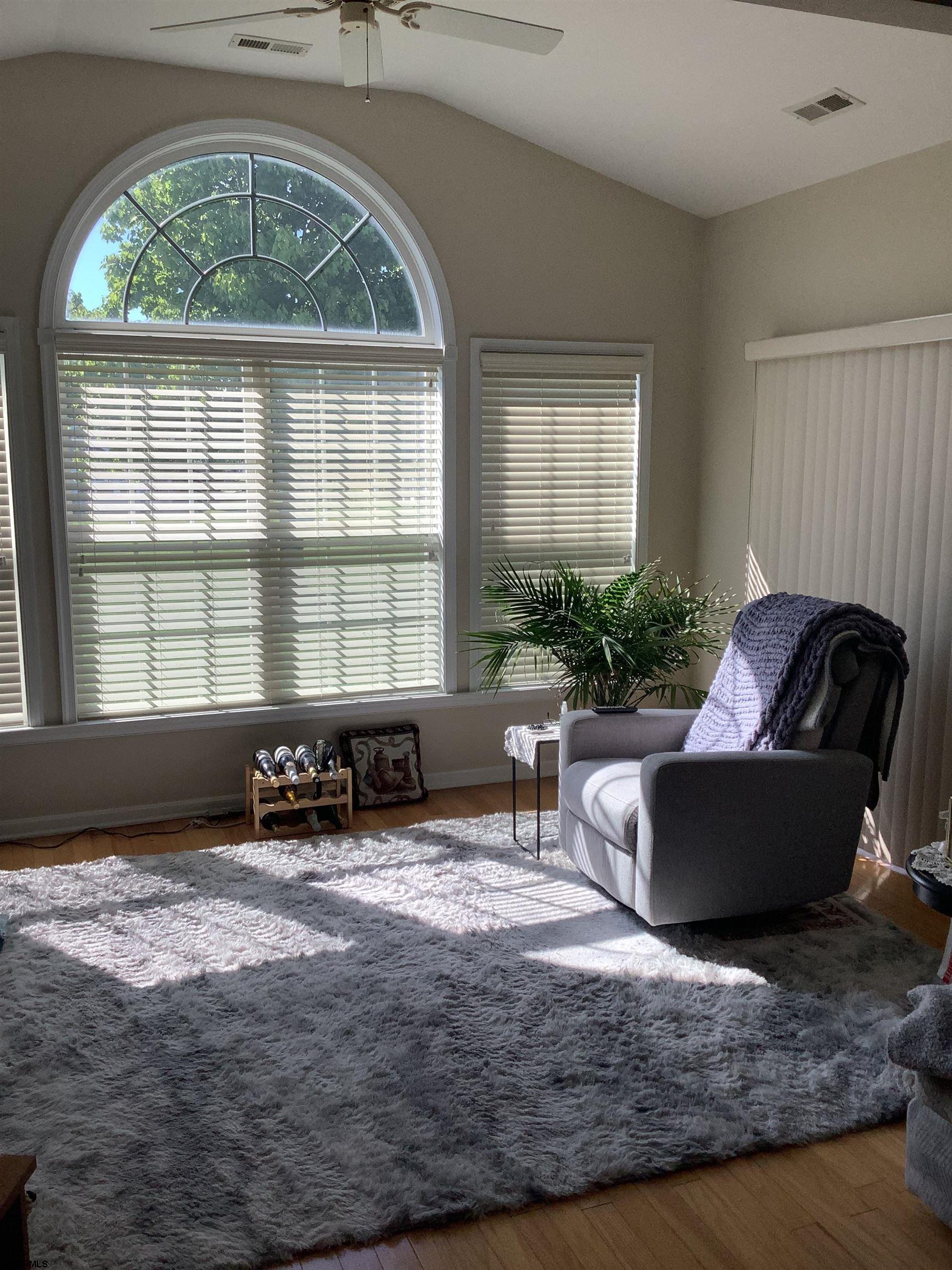 1731 South Shore Road, Unit 128 Marmora, NJ 08230 - Photo 8 of 13 a living room with furniture and a large window
