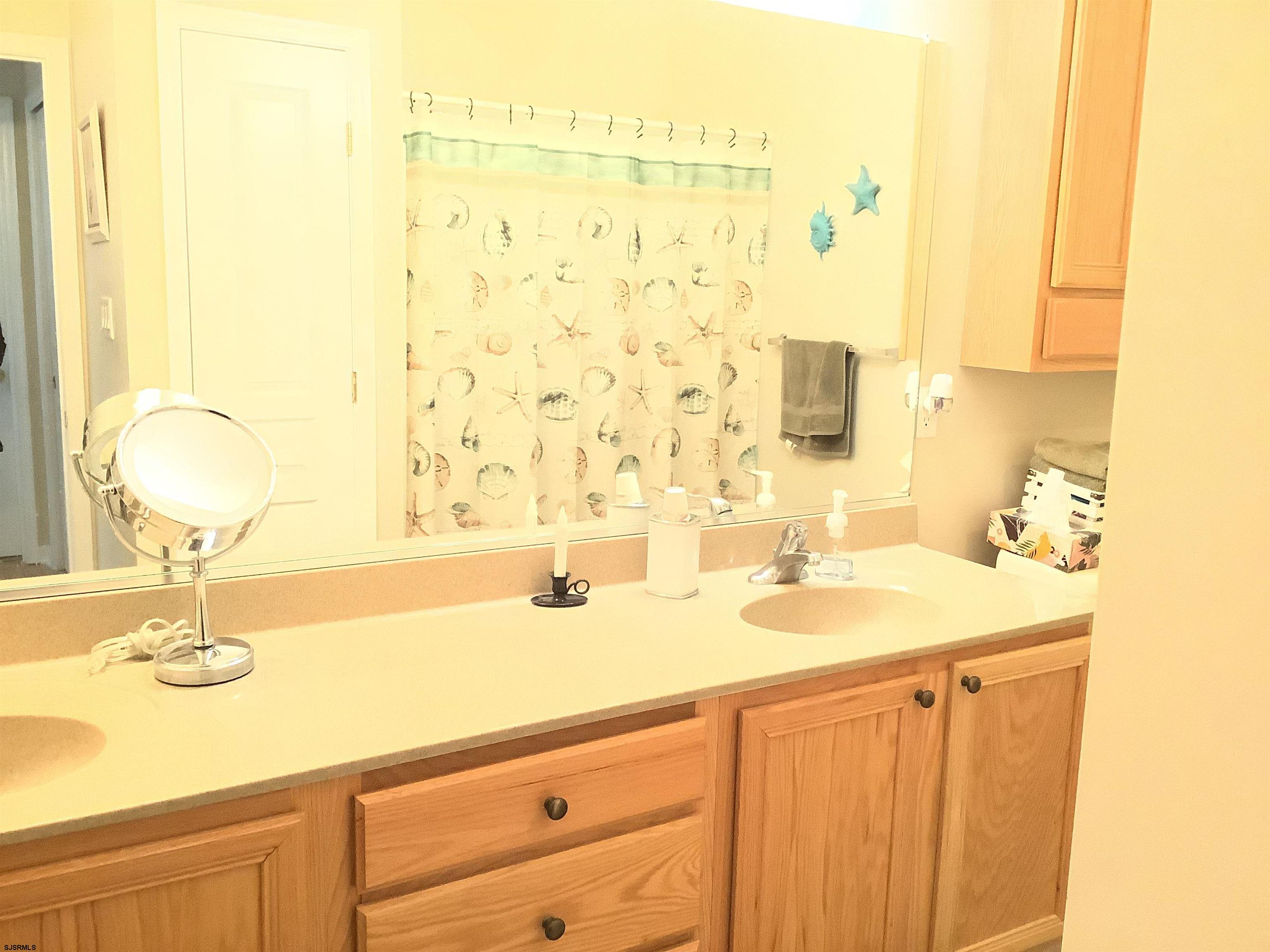 1731 South Shore Road, Unit 128 Marmora, NJ 08230 - Photo 8 of 10 a bathroom with a sink and a mirror