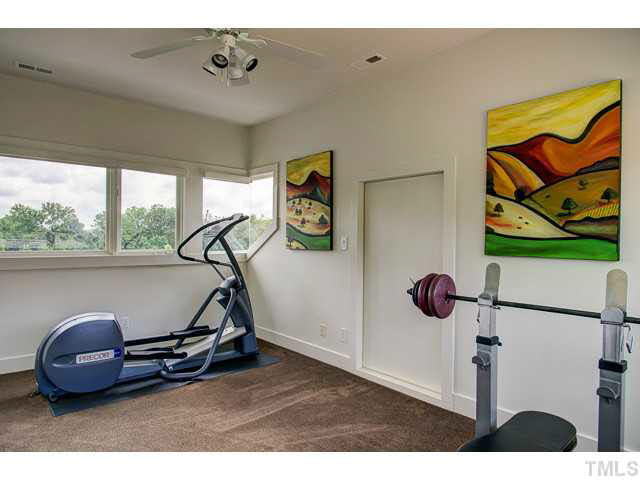 6705 Green Rise Road Hillsborough, NC 27278 - Photo 15 of 24 a room with gym equipment and a large window