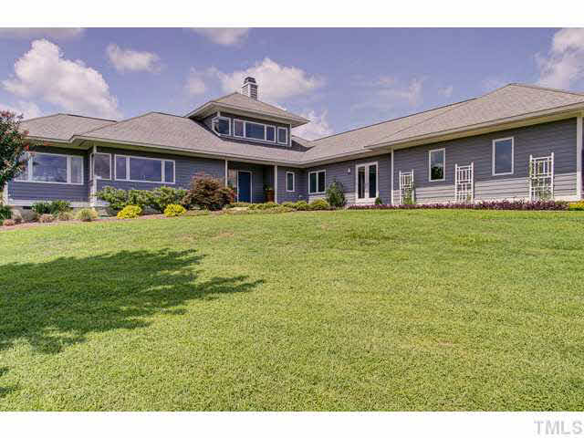 6705 Green Rise Road Hillsborough, NC 27278 - Photo 2 of 24 a front view of a house with a garden