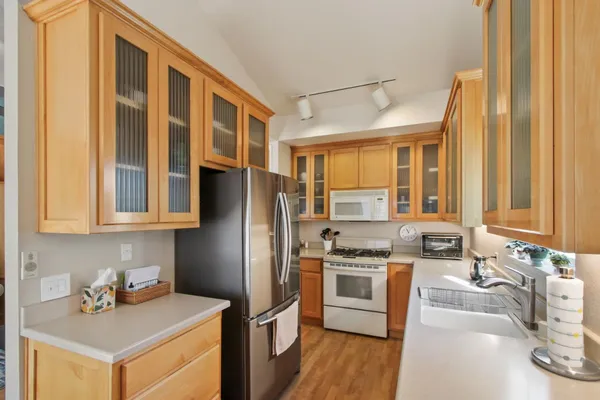 a kitchen with stainless steel appliances a stove a sink and a refrigerator