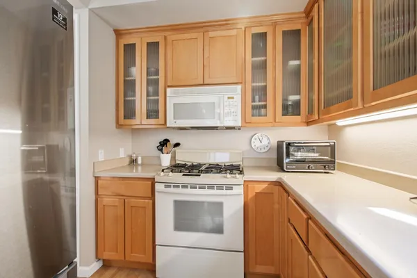 a kitchen with a stove a sink and a refrigerator