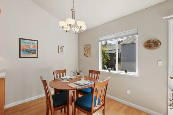 a view of a dining room with furniture wooden floor and chandelier