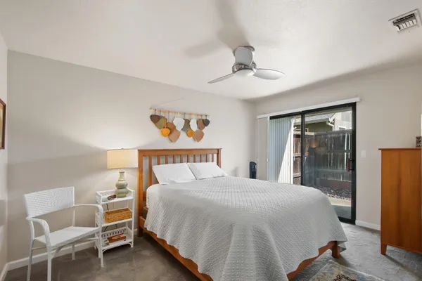 a bedroom with a bed and a large mirror