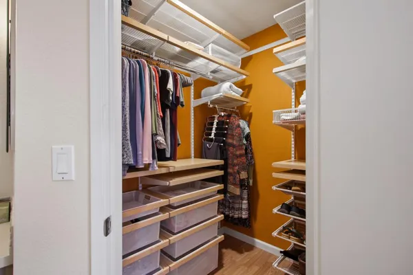 a view of walk in closet with clothes