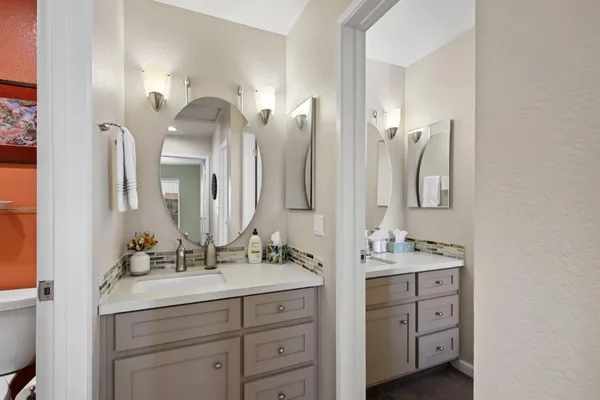 a bathroom with a double vanity sink mirror and next