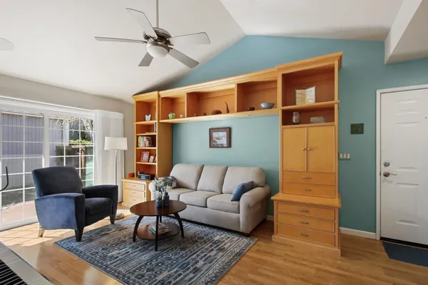 a living room with furniture ceiling fan and a rug