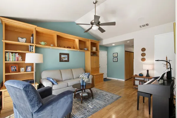 a living room with furniture a ceiling fan and a rug