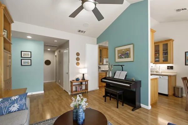 a living room with furniture and wooden floor