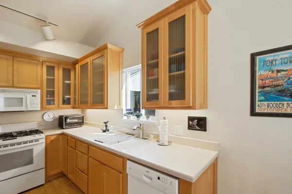 a kitchen with a sink stove and cabinets