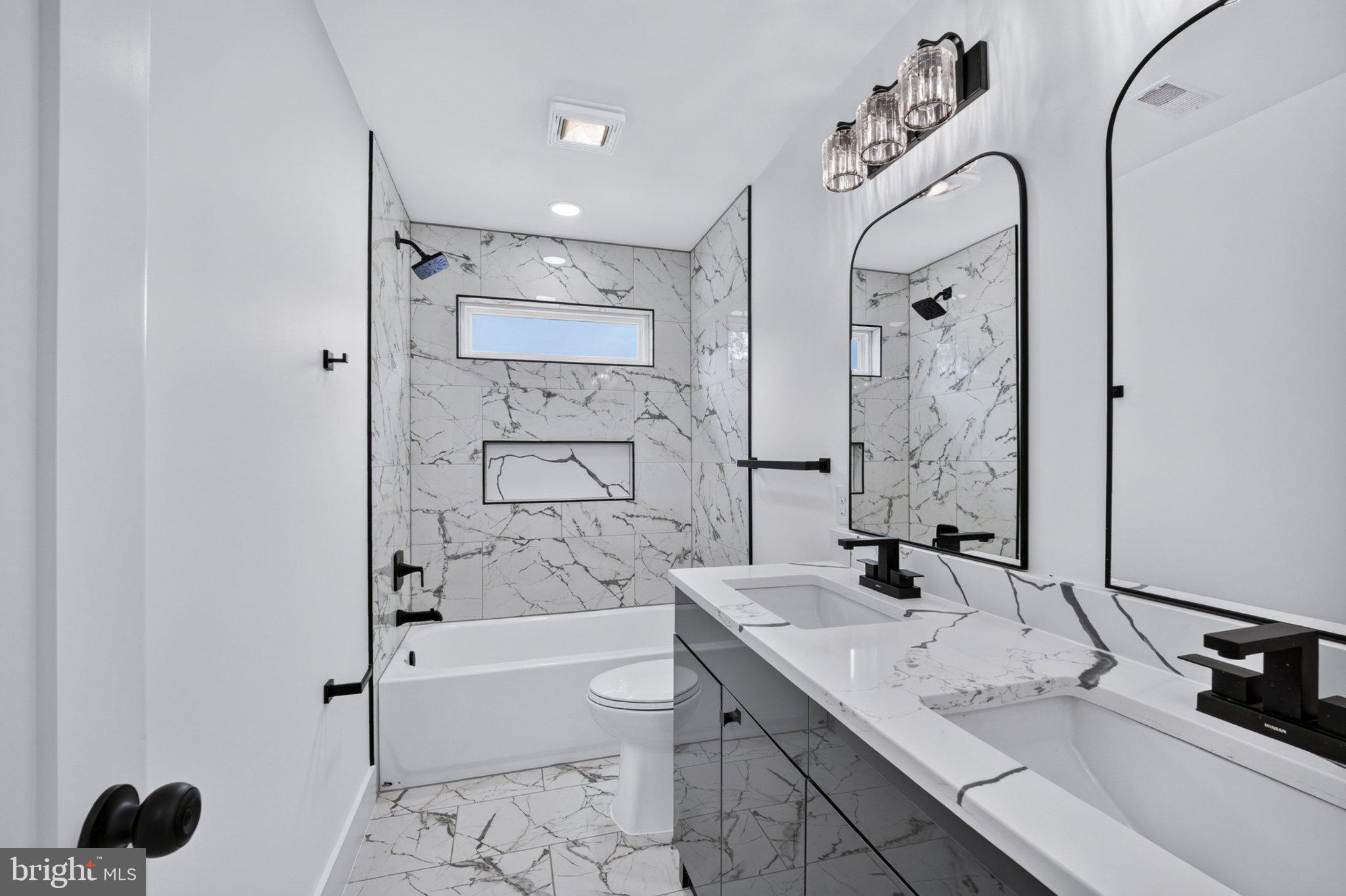8323 Rolling Road Manassas, VA 20110 - Photo 44 of 97 Sleek marble elegance in modern bath.