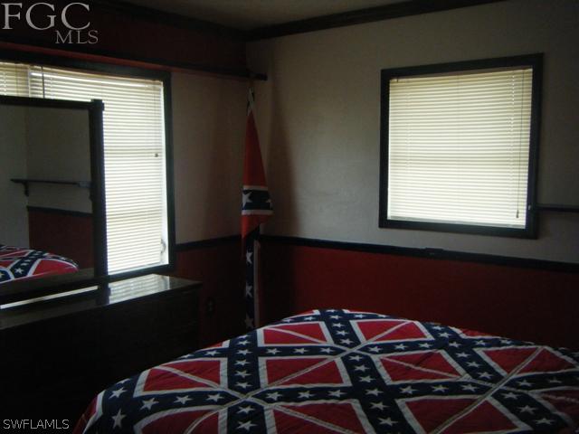 500 Oregon Road West Lehigh Acres, FL 33936 - Photo 5 of 24 a bedroom with a bed and a window