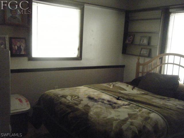 500 Oregon Road West Lehigh Acres, FL 33936 - Photo 6 of 24 a bedroom with a bed and a window