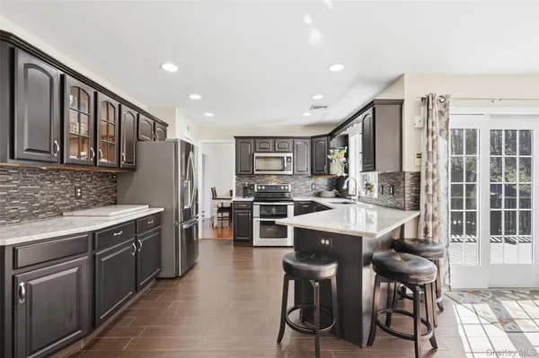 a large kitchen with a table and chairs
