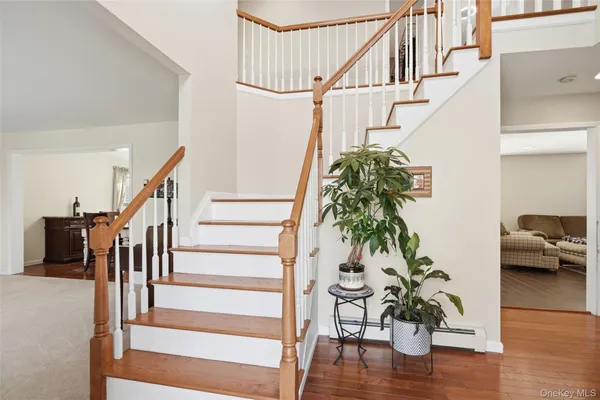 a living room with wooden floor and stairs
