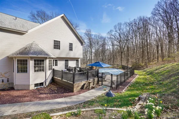 a wooden bench sitting in middle of tall trees