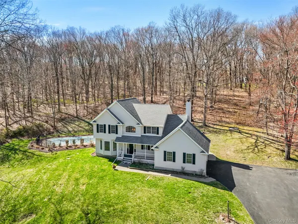a house with tall trees in the background