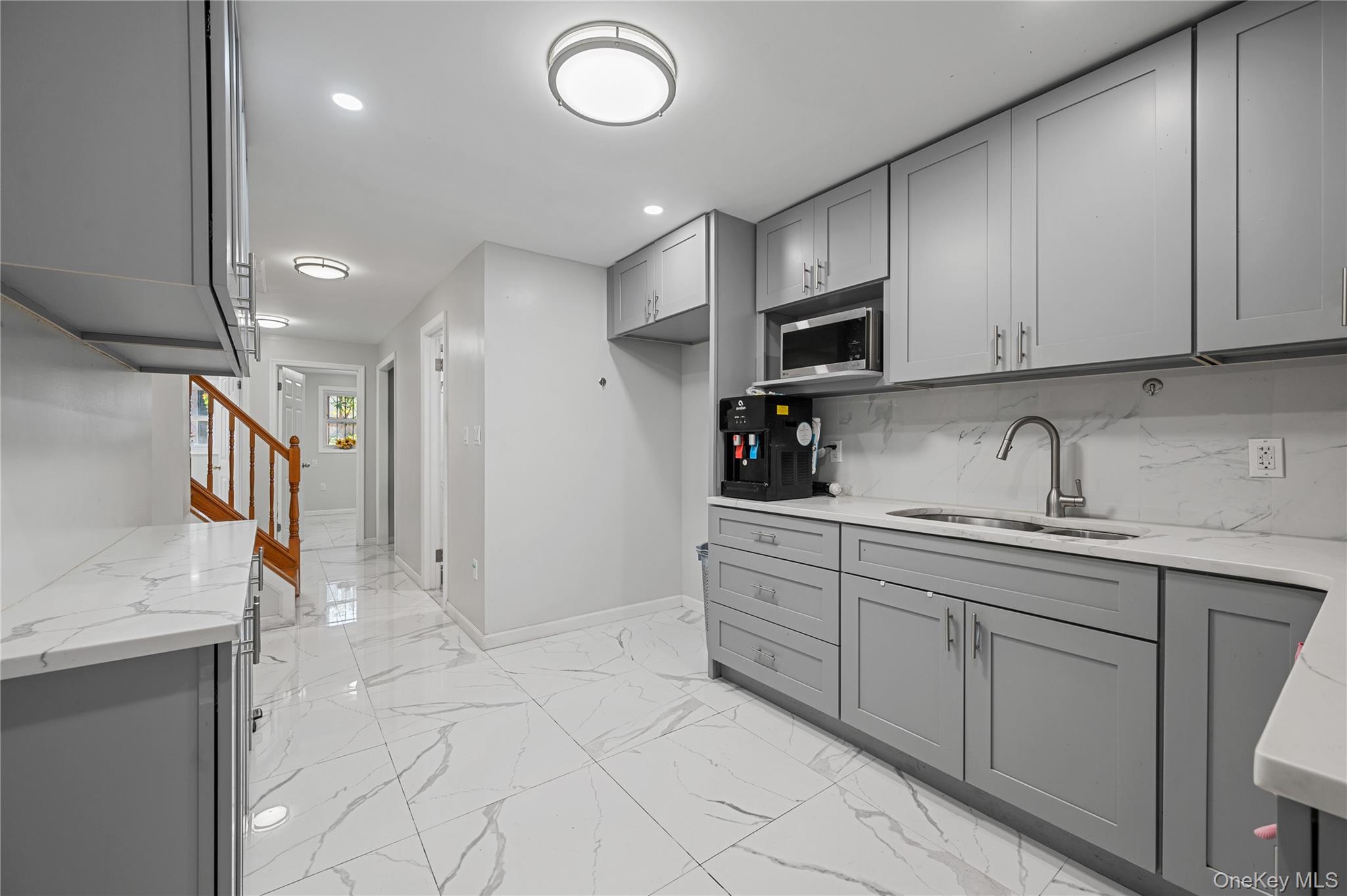 152-10 Peck Avenue Queens, NY 11355 - Photo 12 of 26 Kitchen with gray cabinets, light stone counters, and recessed lighting