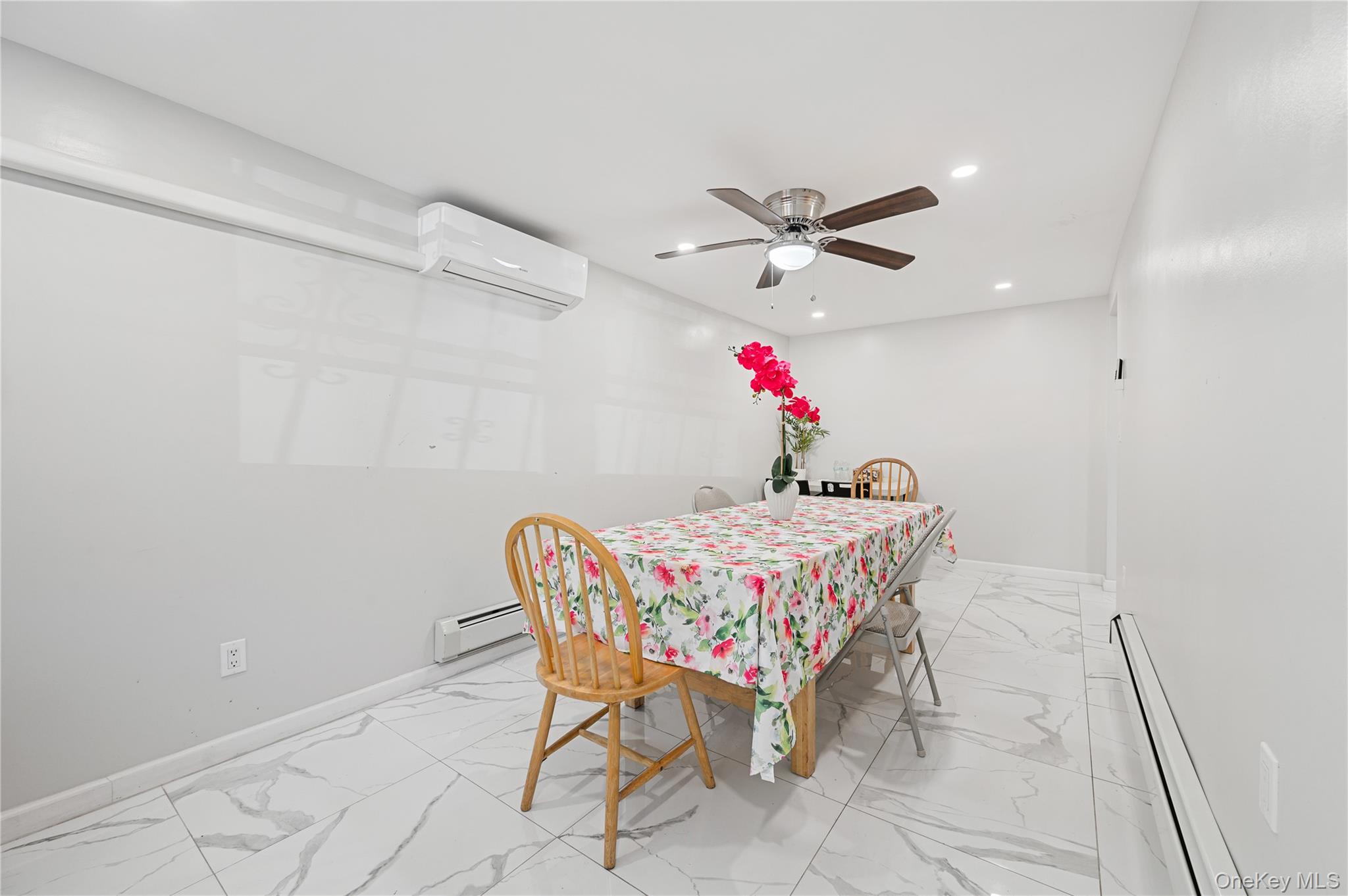 152-10 Peck Avenue Queens, NY 11355 - Photo 13 of 26 Dining room featuring a baseboard radiator, light marble finish flooring, recessed lighting, ceiling fan, and an AC wall unit