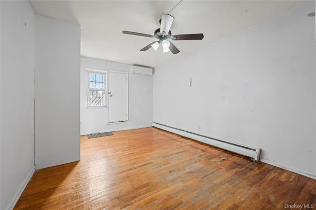 a view of an empty room and wooden floor