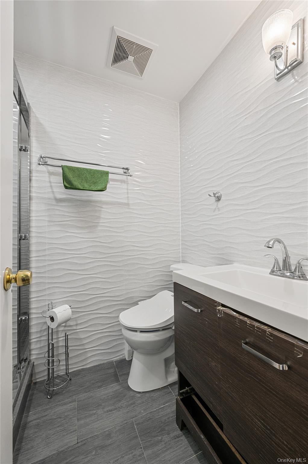 152-10 Peck Avenue Queens, NY 11355 - Photo 17 of 26 Full bathroom with tile walls, vanity, and a stall shower