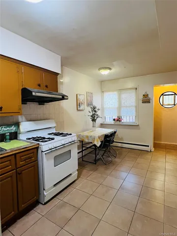 a kitchen with cabinets and chairs