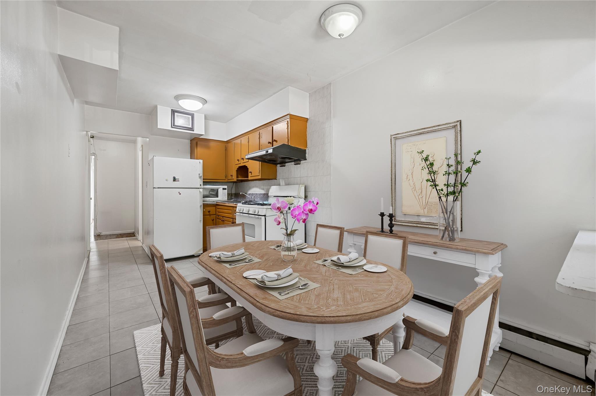 152-10 Peck Avenue Queens, NY 11355 - Photo 3 of 26 Dining room with a baseboard heating unit and light tile patterned flooring