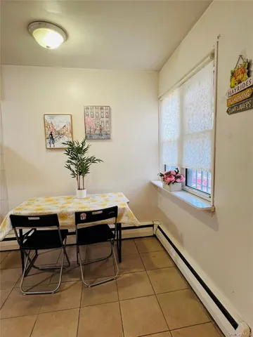 a view of a room with furniture and wooden floor