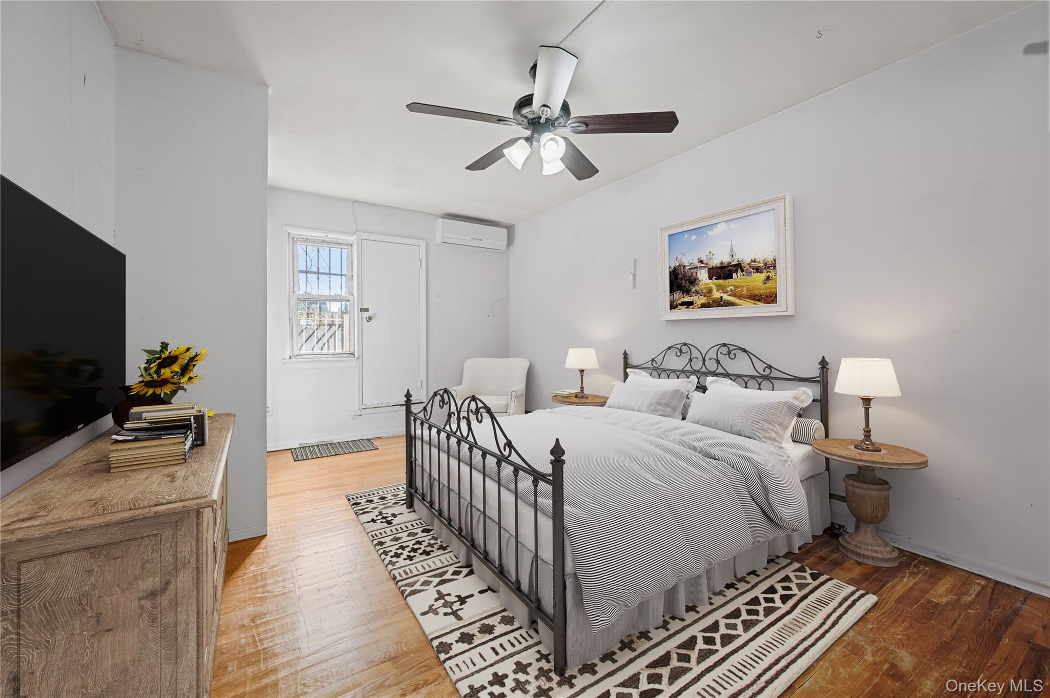 152-10 Peck Avenue Queens, NY 11355 - Photo 5 of 26 Bedroom featuring light wood finished floors, a ceiling fan, and a wall mounted air conditioner