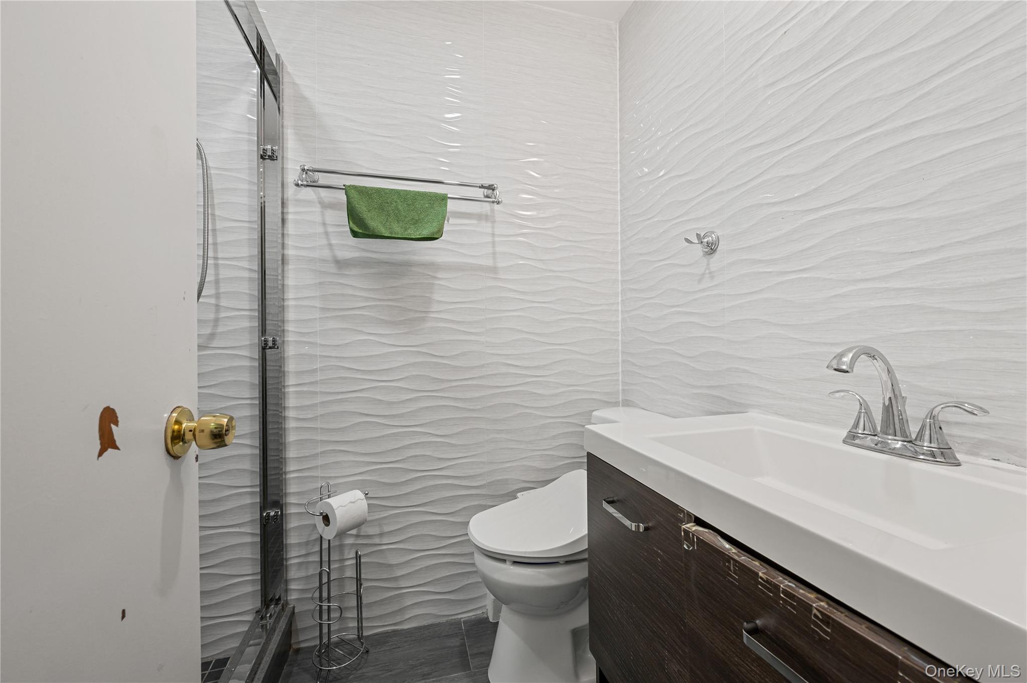 152-10 Peck Avenue Queens, NY 11355 - Photo 9 of 26 Bathroom with vanity and tile walls