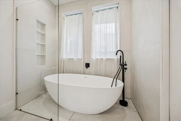 a white bath tub sitting in a bathroom