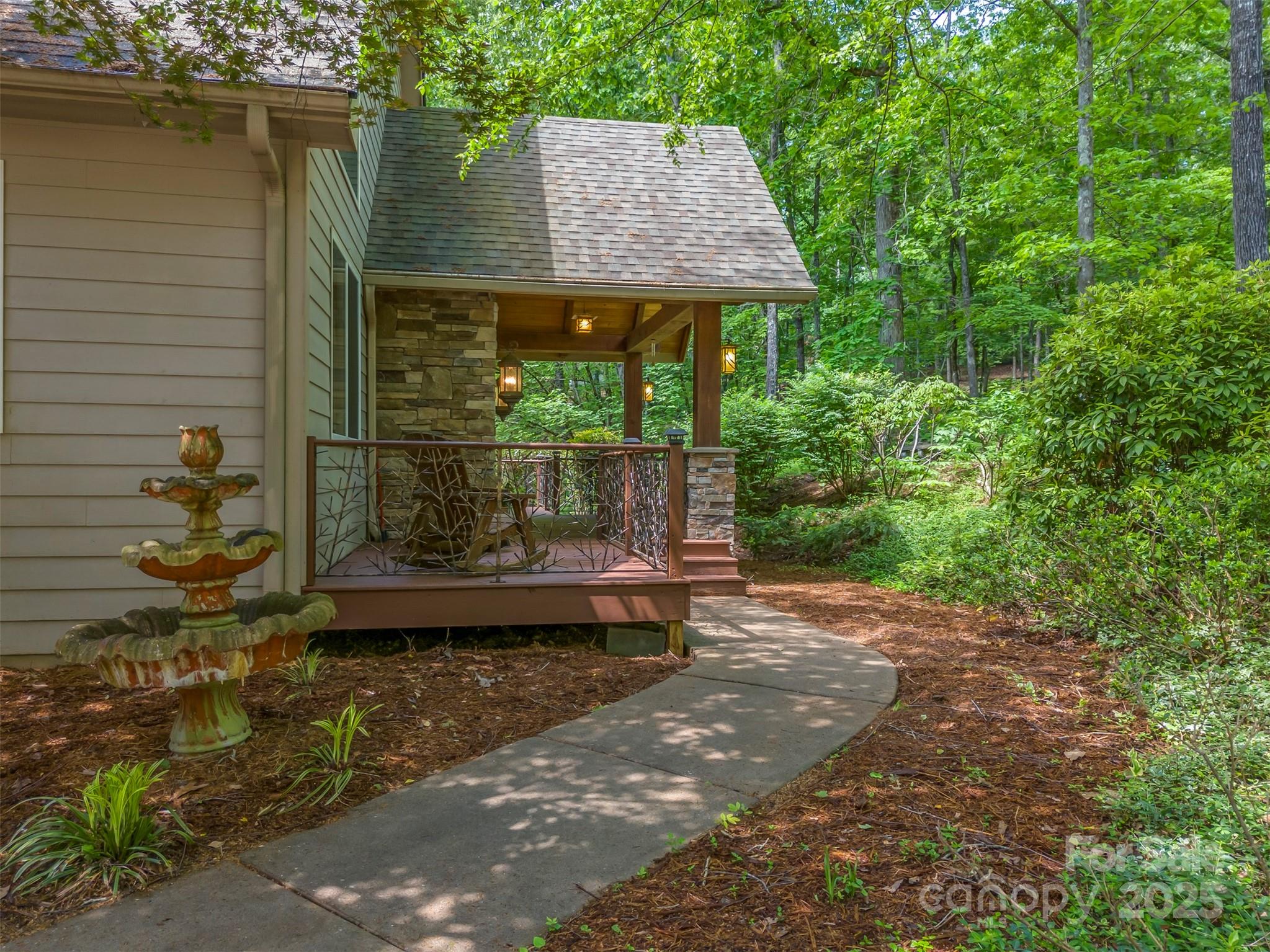 768 White Oak Lane Tryon, NC 28782 - Photo 2 of 48 a backyard of a house with a garden and outdoor seating