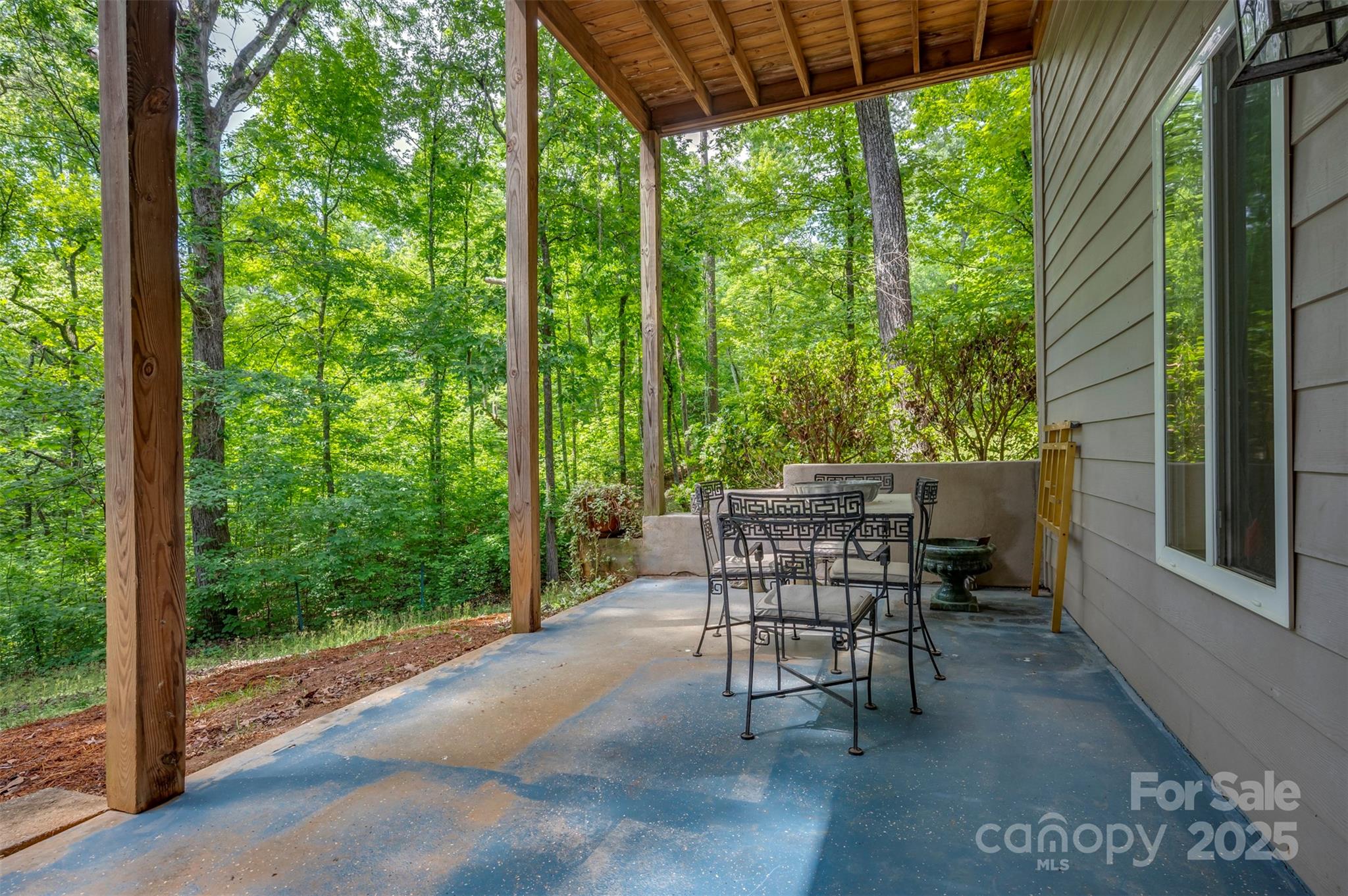 768 White Oak Lane Tryon, NC 28782 - Photo 36 of 48 a view of a patio with a table chairs and backyard