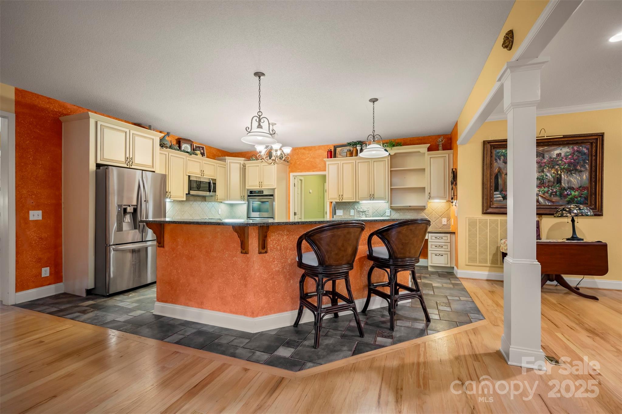 768 White Oak Lane Tryon, NC 28782 - Photo 9 of 48 a kitchen with stainless steel appliances kitchen island granite countertop a refrigerator a stove a sink and a dining table with wooden floor