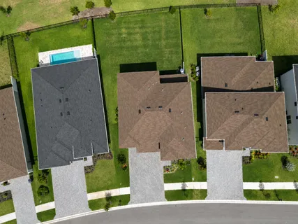 an aerial view of a house with a swimming pool
