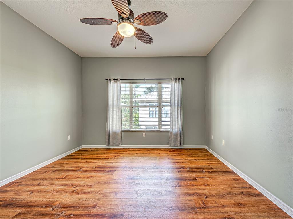 1801 Highland Road Osprey, FL 34229 - Photo 20 of 40 a view of empty room with wooden floor and fan