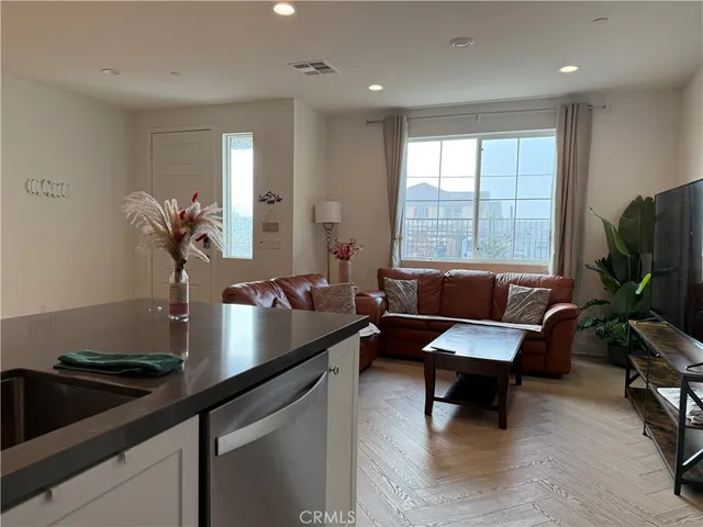 a living room with furniture and a potted plant