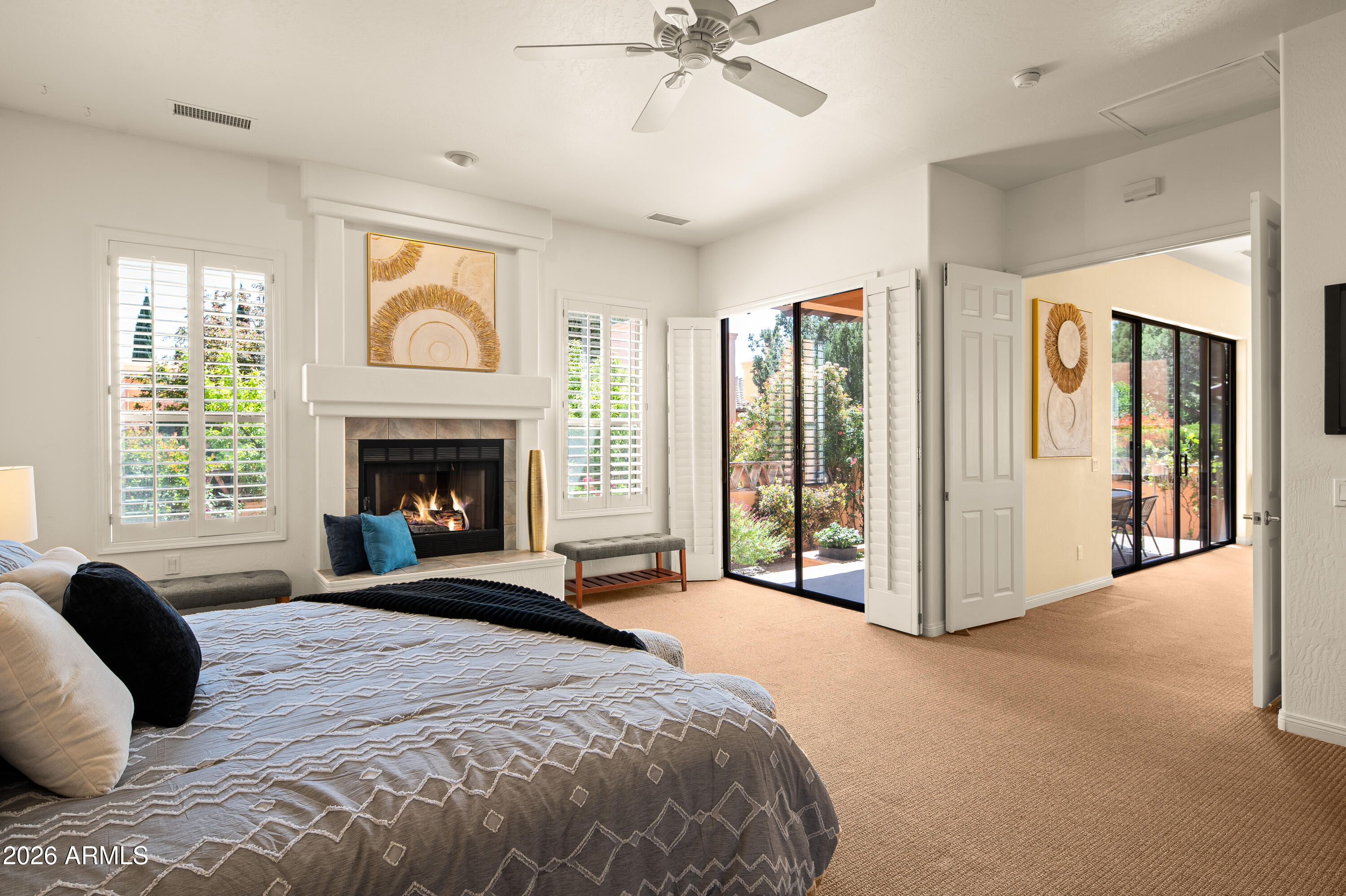39 Rim Trail Circle Sedona, AZ 86351 - Photo 16 of 41 a spacious bedroom with a large bed and a fireplace