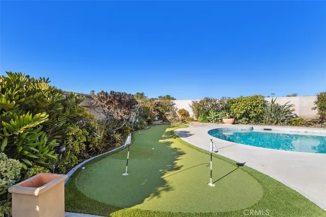 a view of a swimming pool with a yard