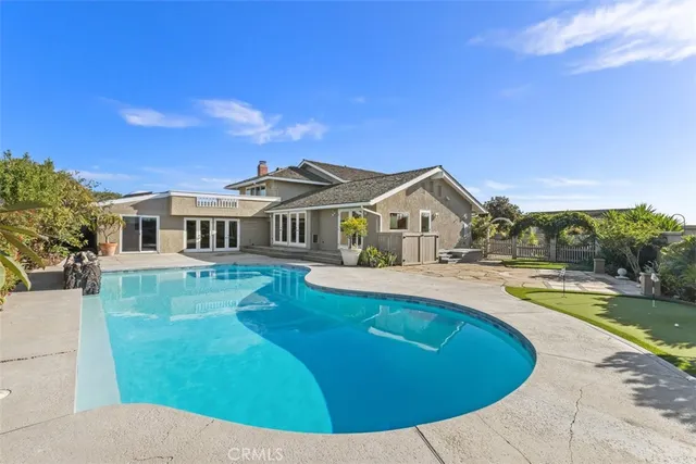 a view of a swimming pool and an outdoor seating