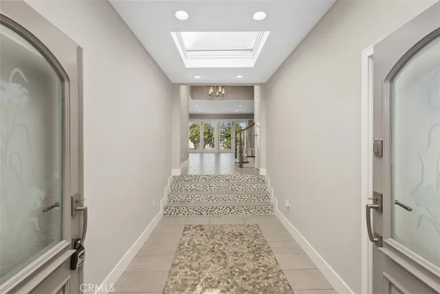 a kitchen with granite countertop a stove a sink a dining table and chairs