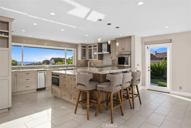 a kitchen with stainless steel appliances granite countertop a sink and stove top oven