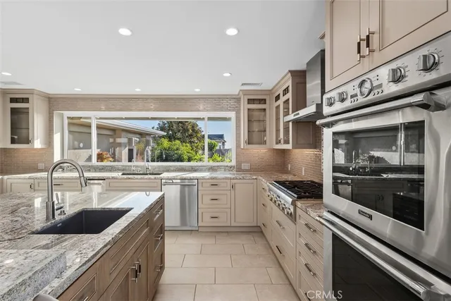 a large kitchen with cabinets and a fireplace