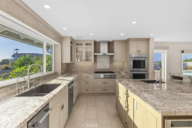 a kitchen with a sink appliances and cabinets