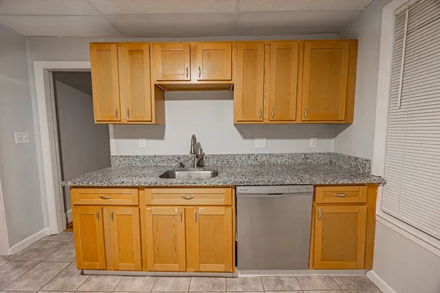 a kitchen with stainless steel appliances granite countertop a sink and cabinets